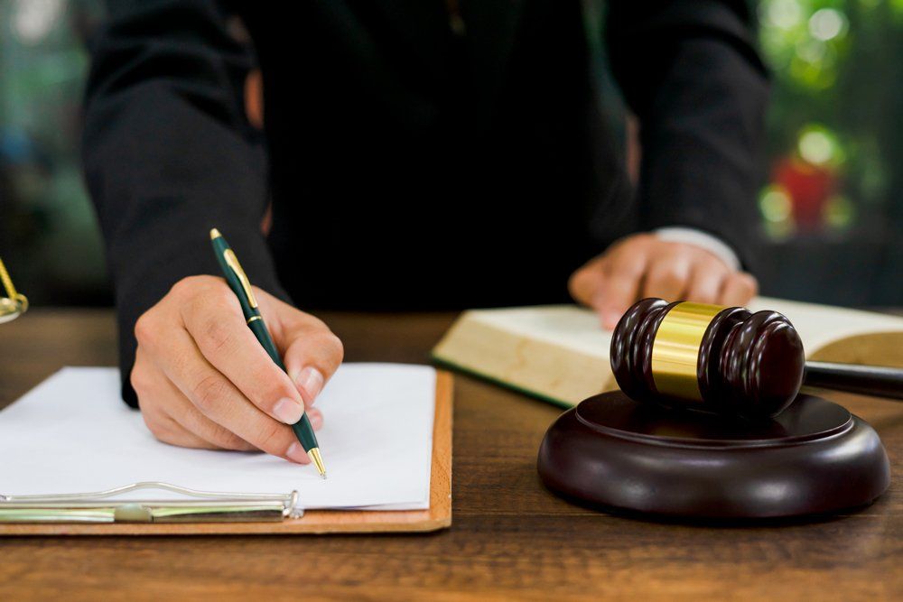 Attorney Writing On A Paper — Gibsonville, NC — Walker & Bullard PA