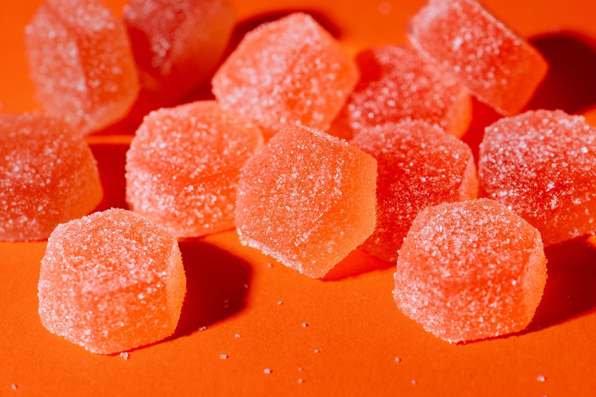 A pile of honeybee gumdrops on an orange background