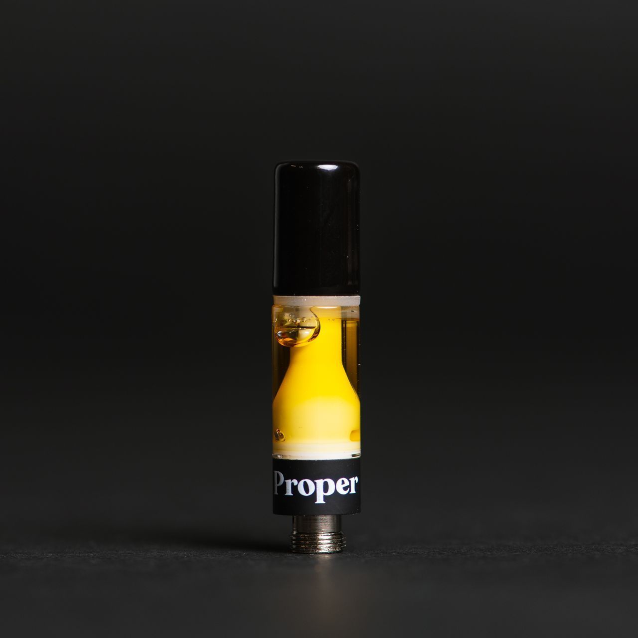 Proper Cannabis Liquid Diamond vape cartridge on a black background