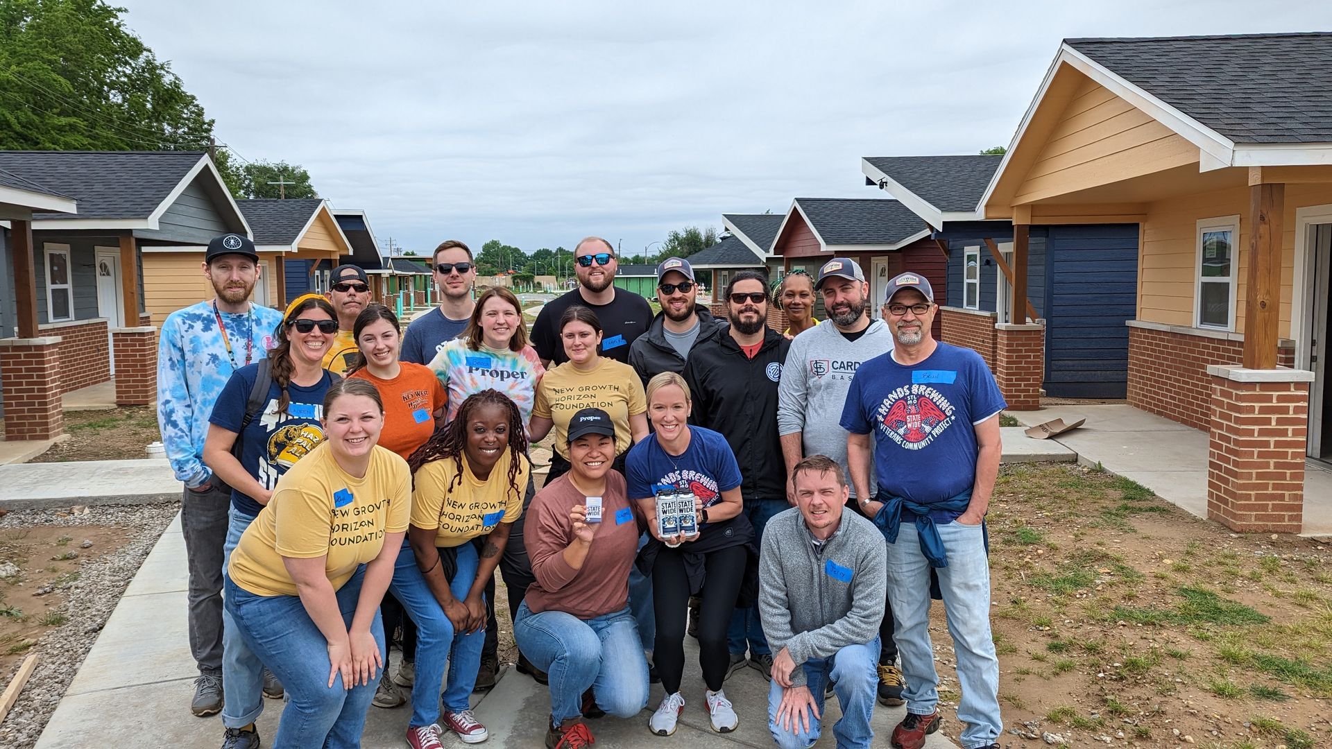 Proper and 4Hands teams posing after volunteering at the Veterans Community Project