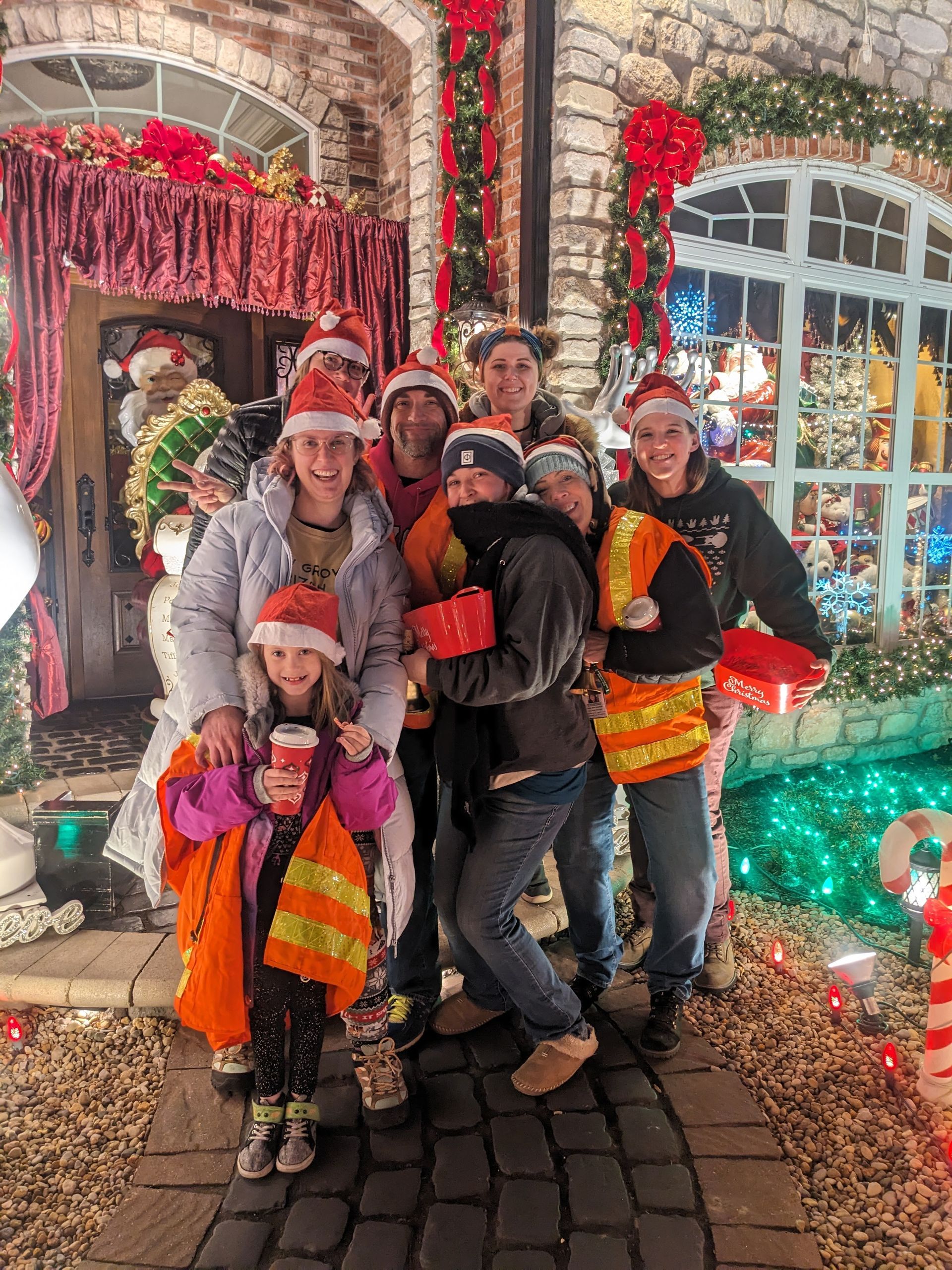 Volunteers collecting donations at a colorfully decorated Christmas lights display
