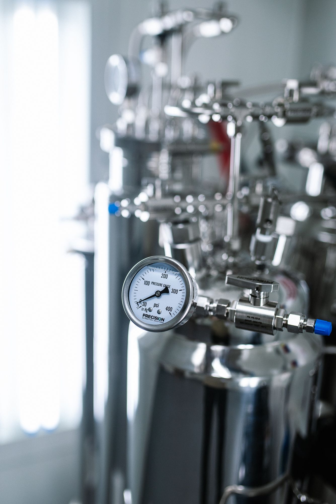 A close up of a pressure gauge on a machine in the extraction lab.