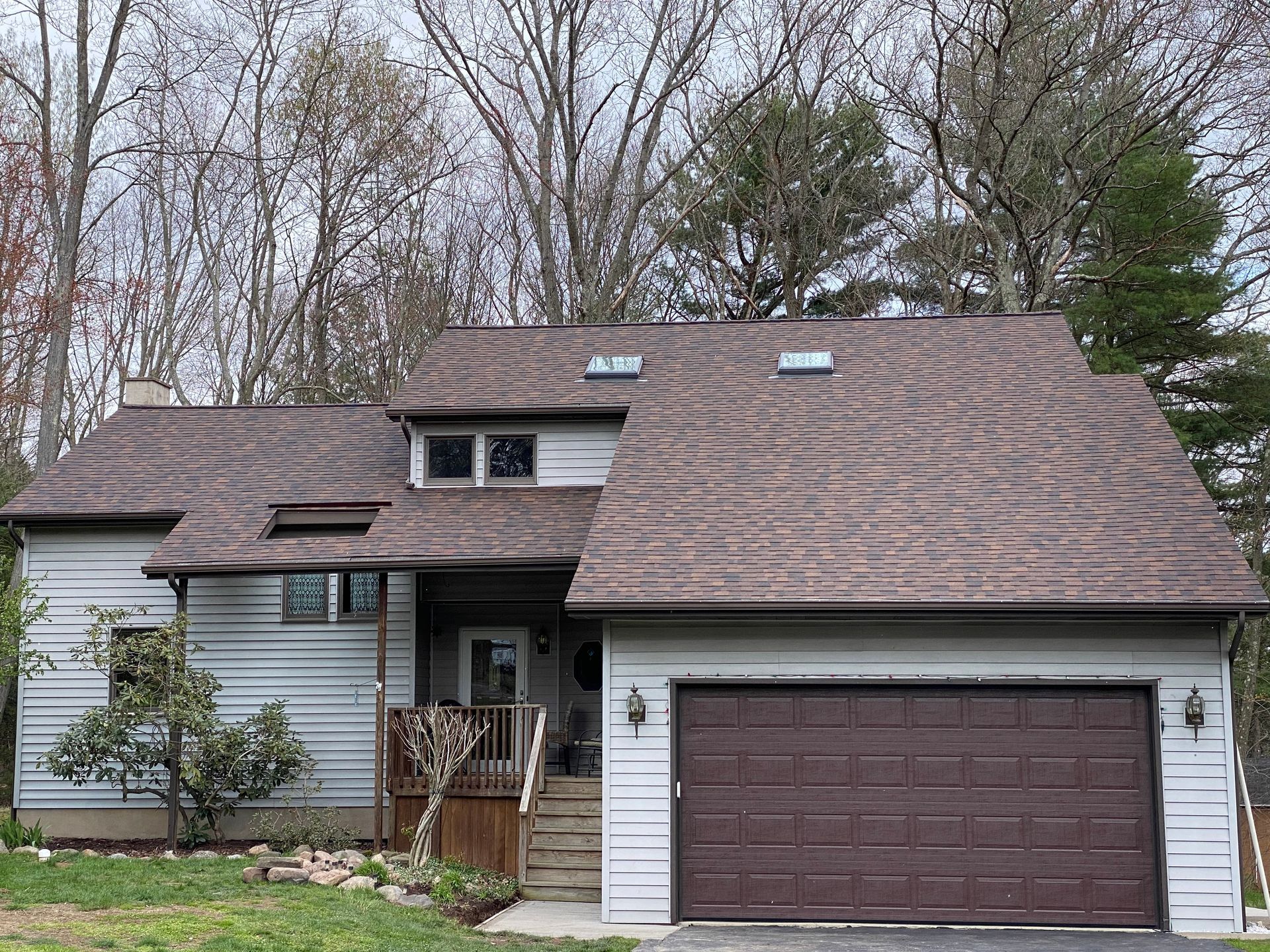 A house with a brown garage door and a brown roof
