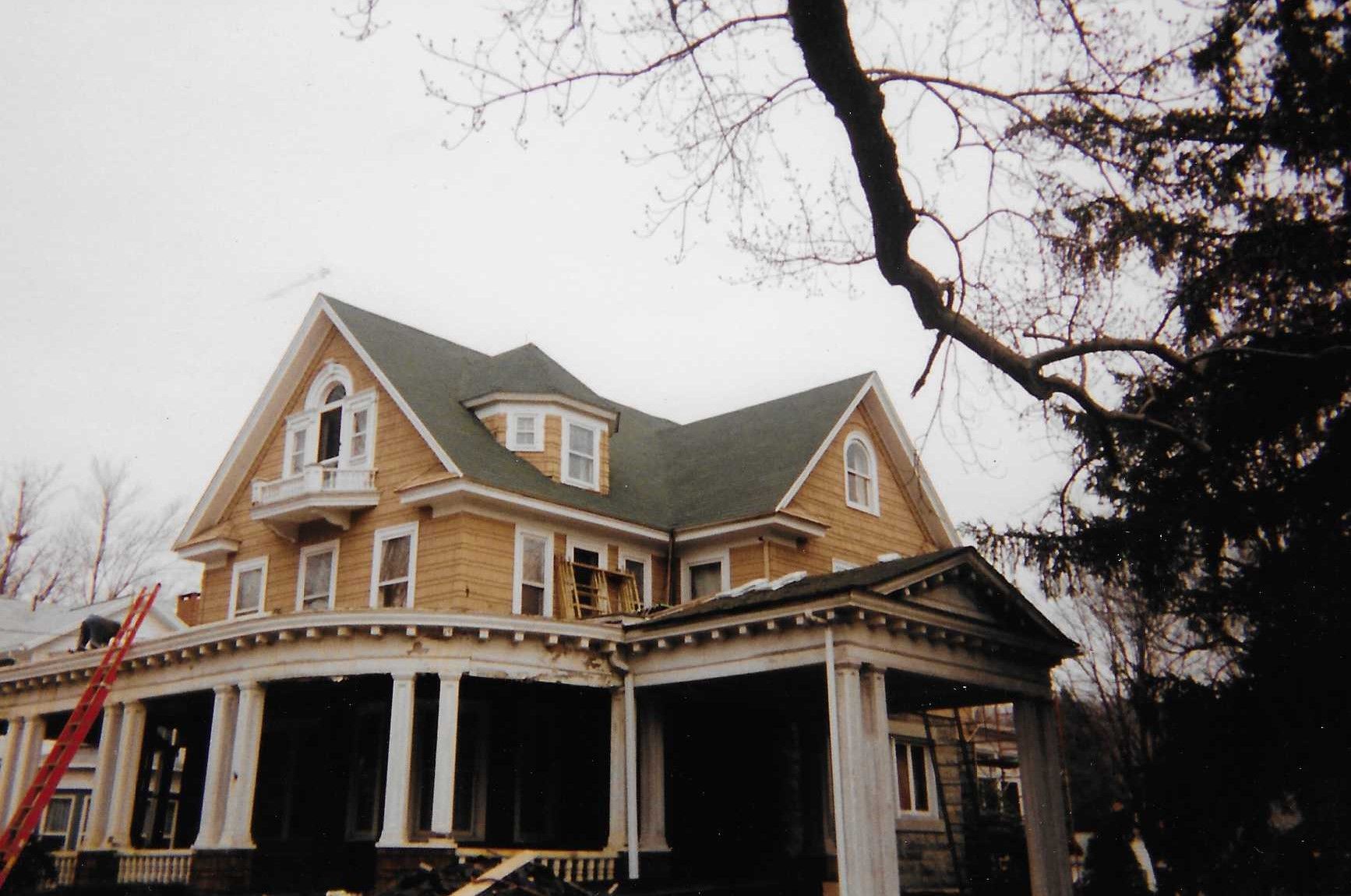 A large brick house with a large window on the roof