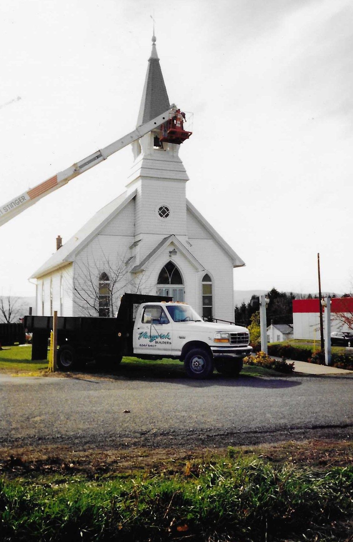 The roof of a house under construction with a blue sky in the background.