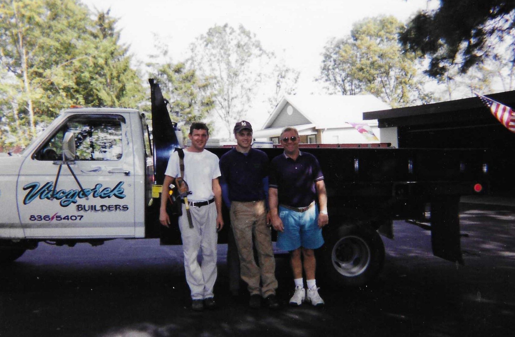 A brick house with a porch and a gray roof