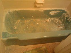 A bathtub is being painted in a bathroom.