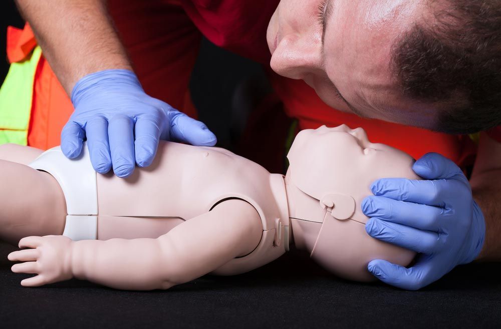 CPR Training with Baby Dummy — First Aid Industrial Medical In Newcastle, NSW