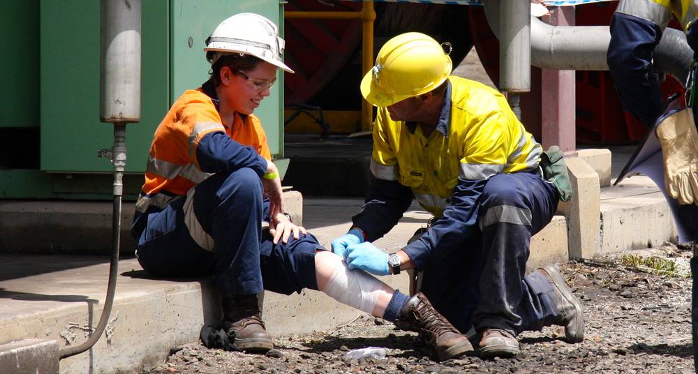 Medic Applying First Aid To the Woman — First Aid Industrial Medical In Taree, NSW