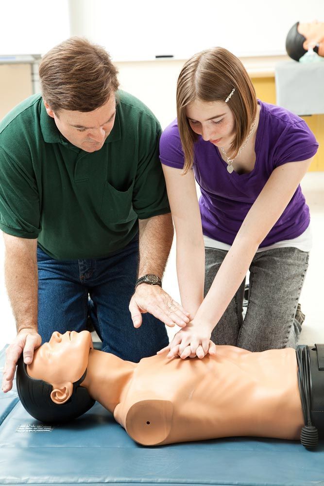 Teen Girl Practicing CPR on A Dummy — First Aid Industrial Medical In Newcastle, NSW