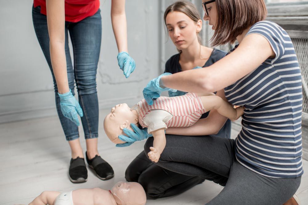 Demonstrating CPR on a Baby Dummy — First Aid Industrial Medical In Muswellbrook, NSW