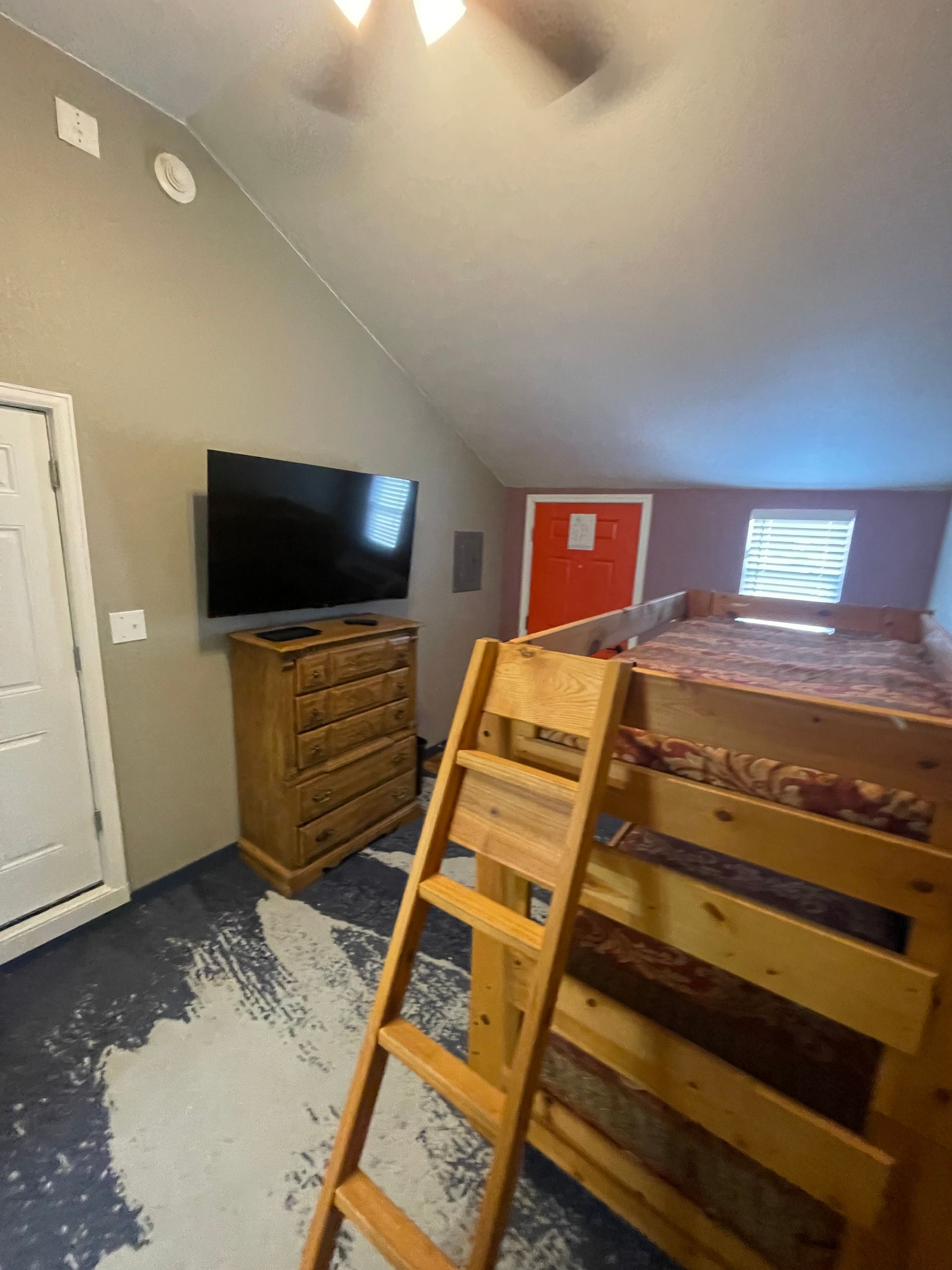 Luxury hotel suite with a king bed, bunk beds, a fireplace, and mountain views.