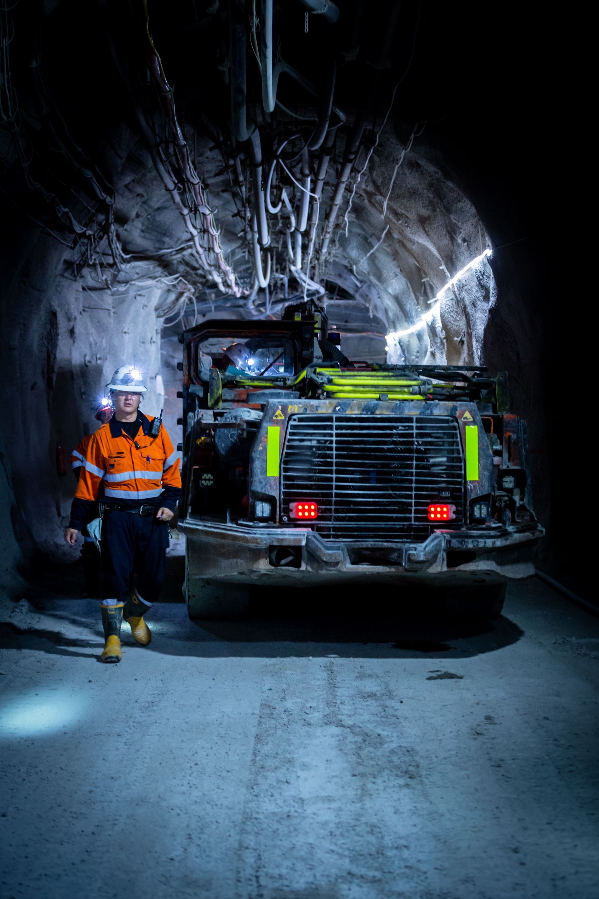 A Man is Standing in Front of a Truck in a Tunnel — Calibre Resourcing Solutions in Mount Isa City, QLD