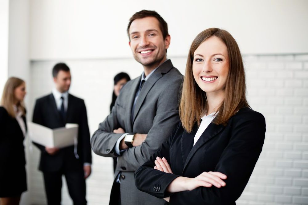 A Man and a Woman Are Posing for a Picture With Their Arms Crossed — Calibre Resourcing Solutions in Mount Isa City, QLD
