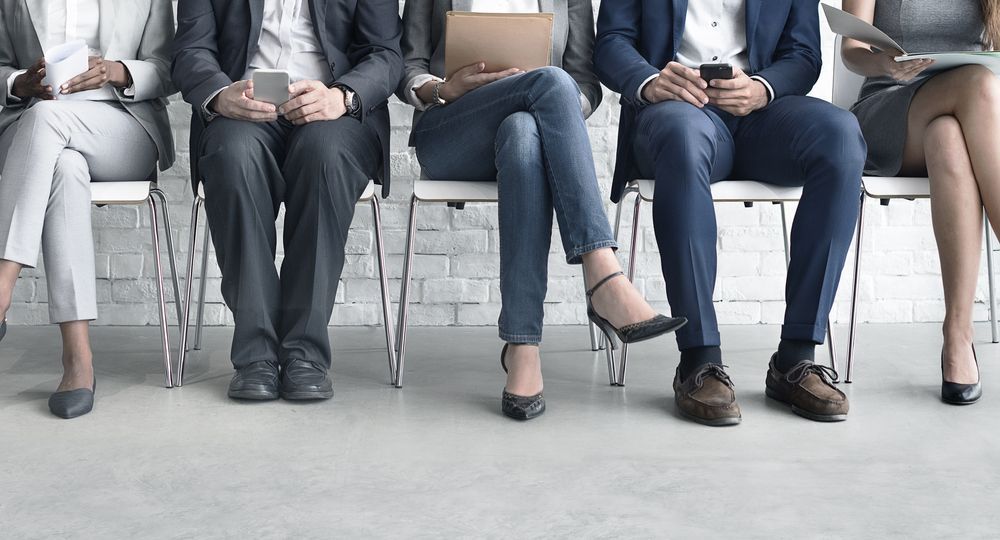 A Group of People Are Sitting in Chairs Waiting for a Job Interview — Calibre Resourcing Solutions in Cairns, QLD