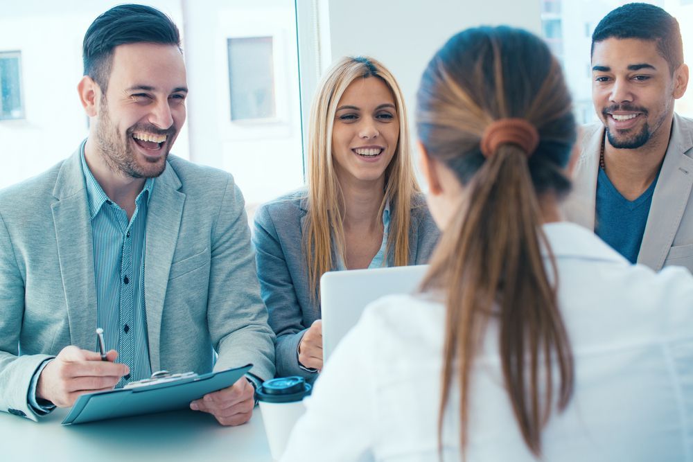 A Group of People Are Sitting at a Table Having a Job Interview — Calibre Resourcing Solutions in Mount Isa City, QLD
