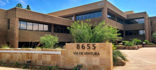 A large brick building with a sign in front of it that says 8655 ata de ventura.