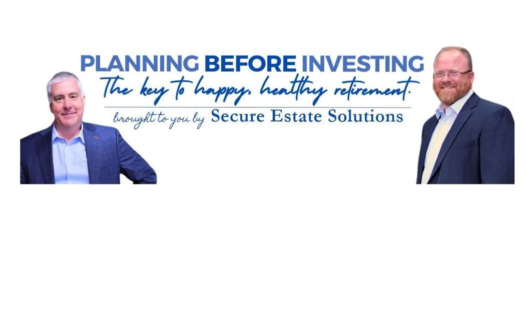 Two men are standing next to each other in front of a sign that says planning before investing.