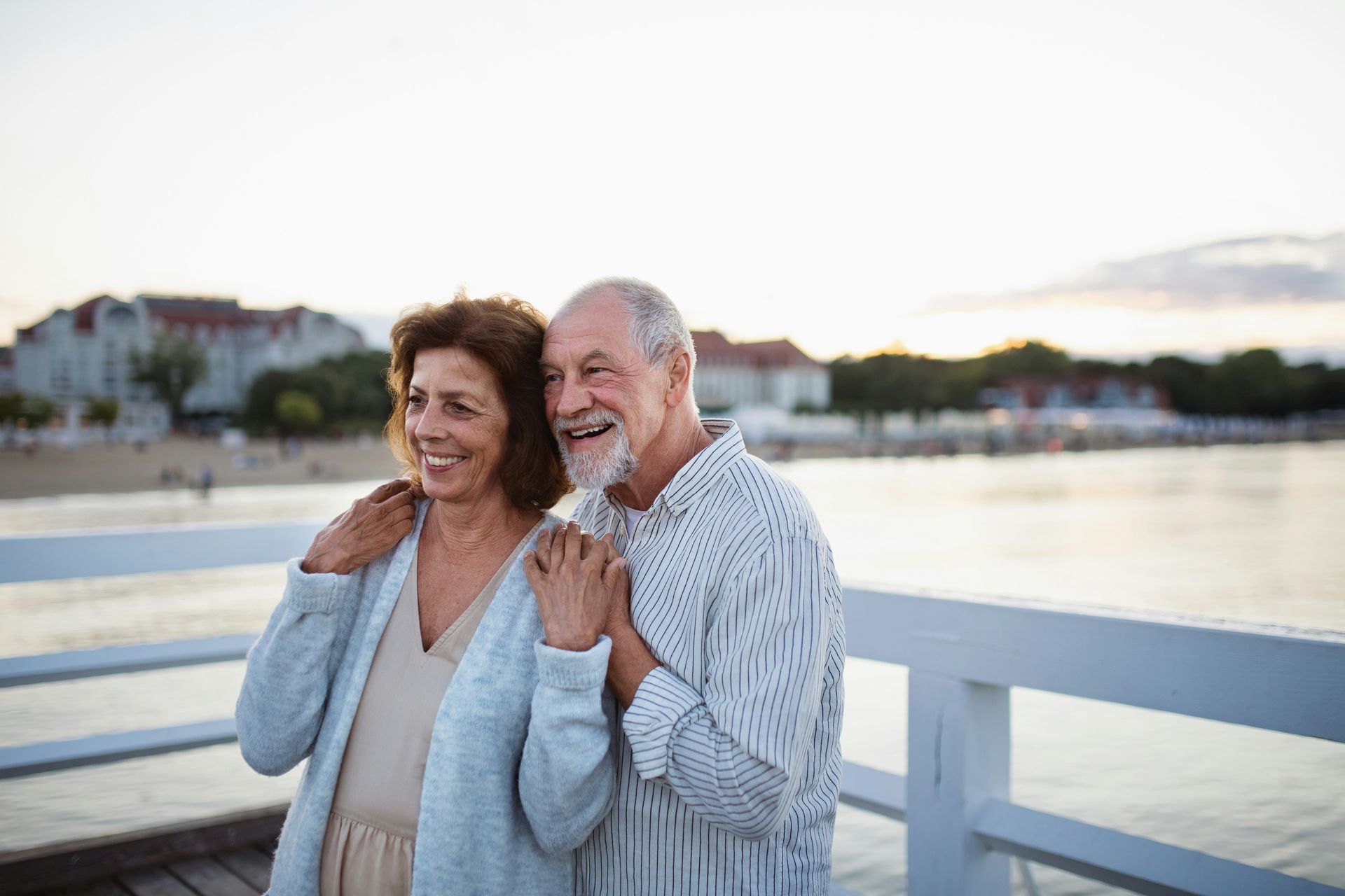 A man and a woman are dancing on the beach.