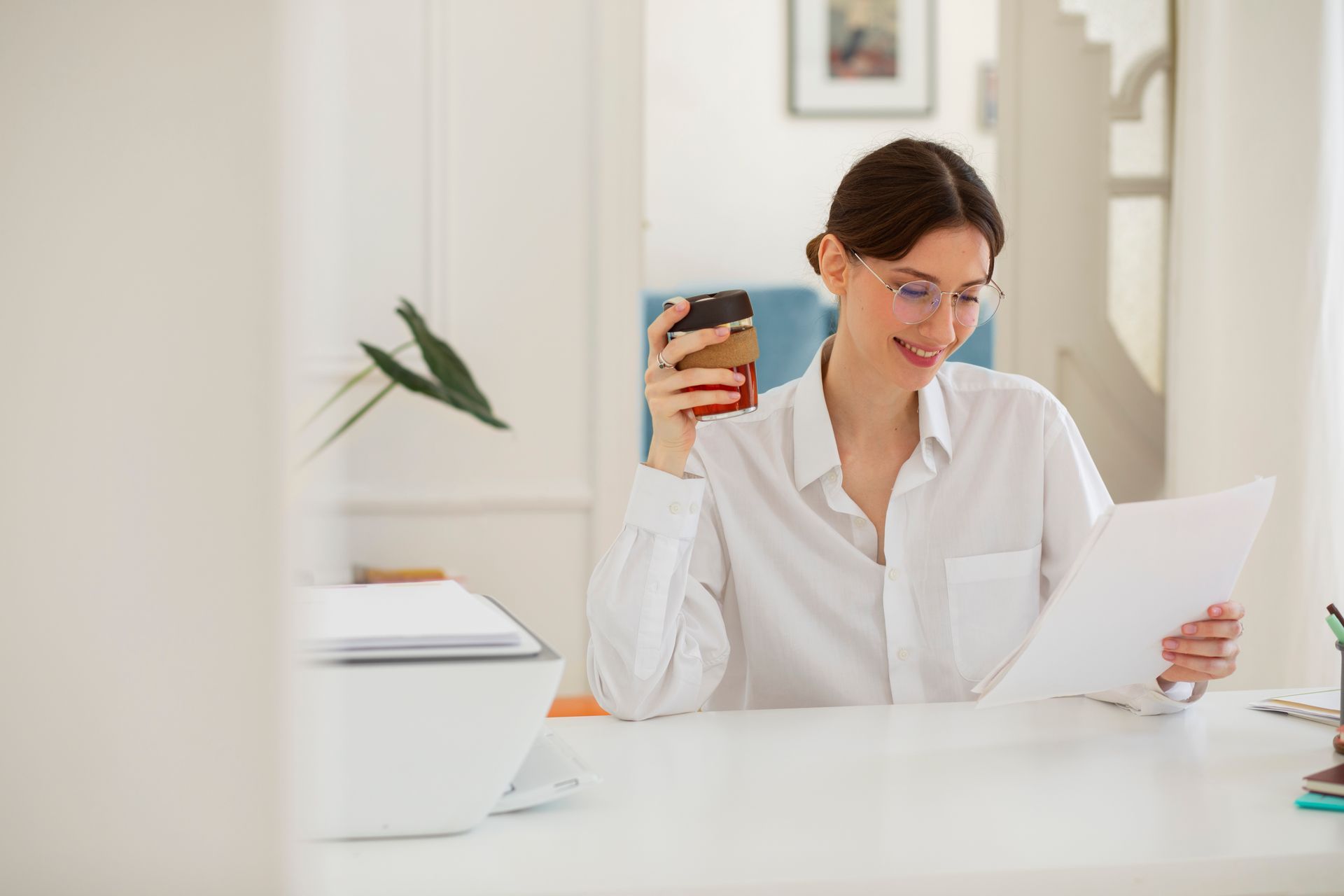 A person is typing on a laptop computer while sitting on a couch.