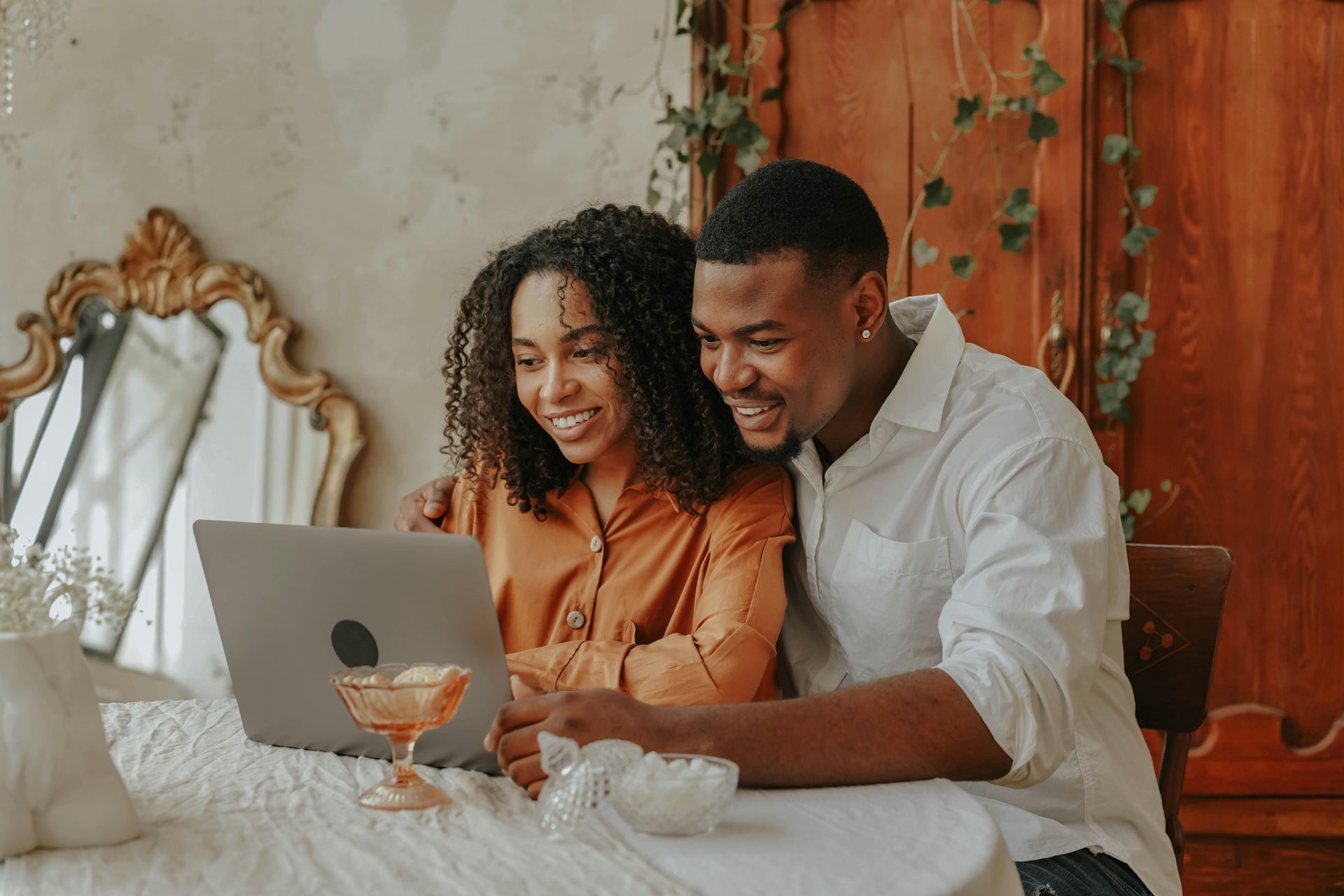 A man and a woman are sitting at a table in a restaurant looking at a menu.
