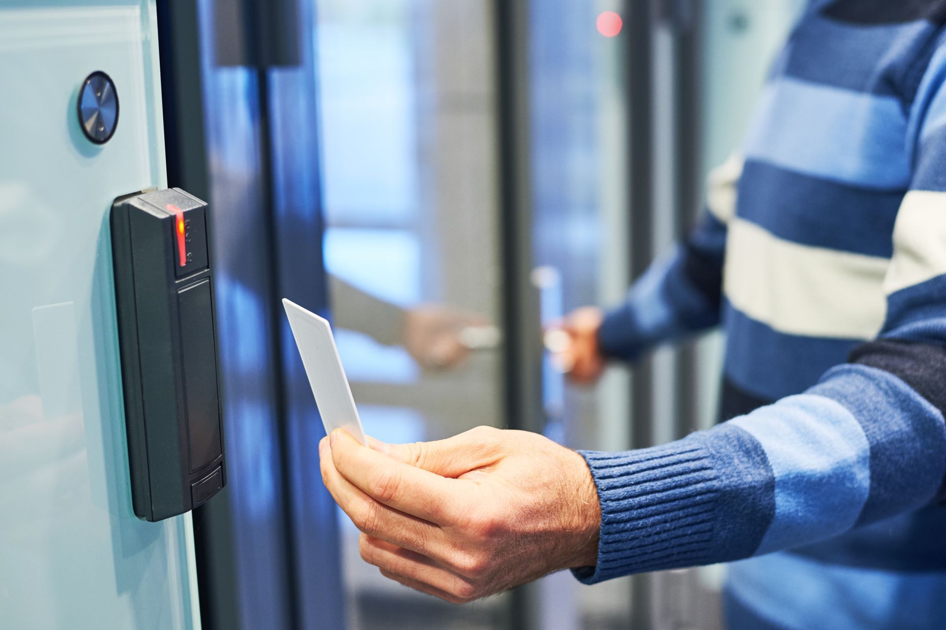 A worker uses an electronic card key for access.