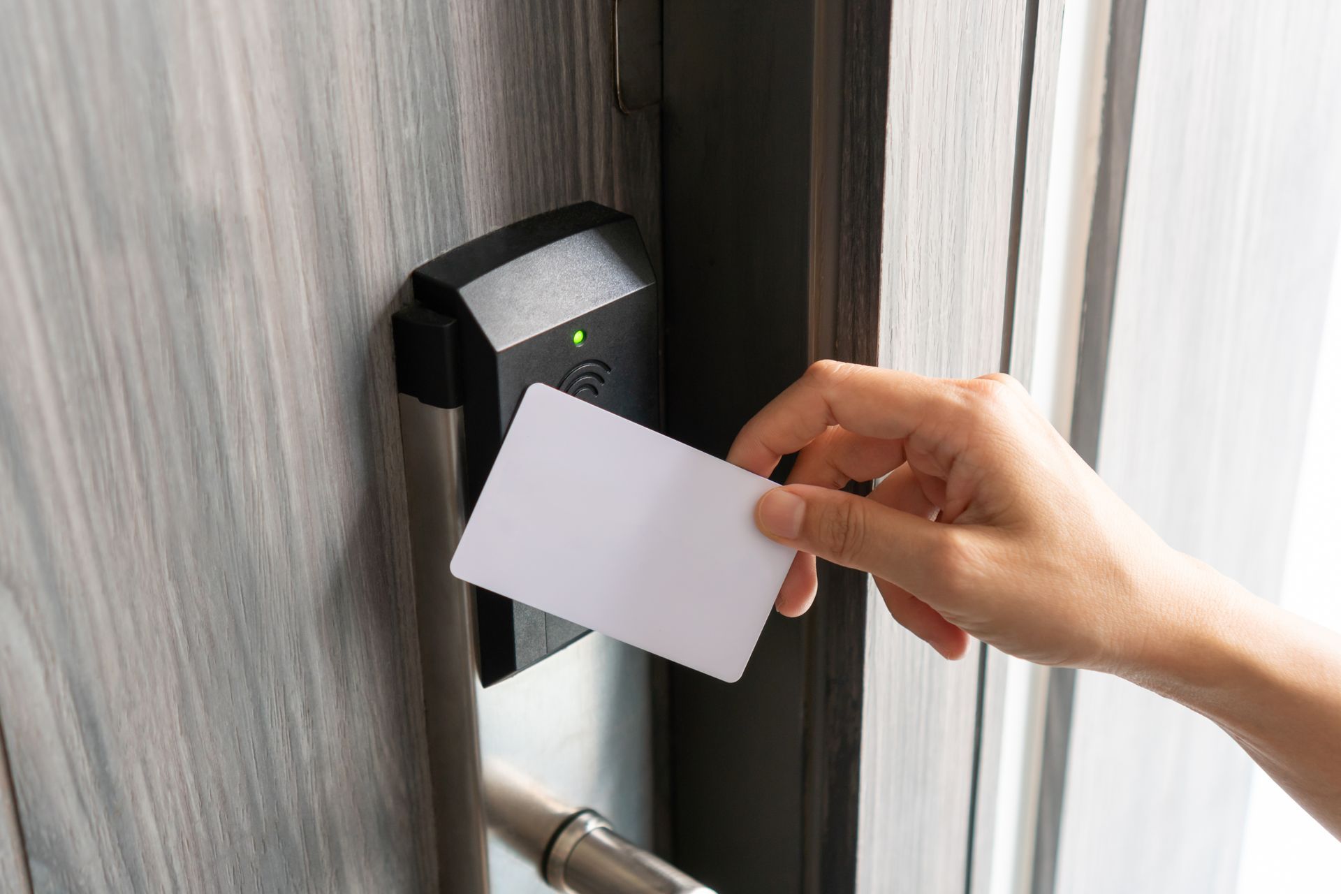 A person is using an electronic smart key to unlock a door.