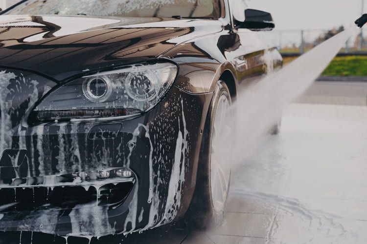 Picture showcasing a professional worker providing a full car valet