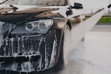 Picture showcasing a professional worker providing a full car valet.