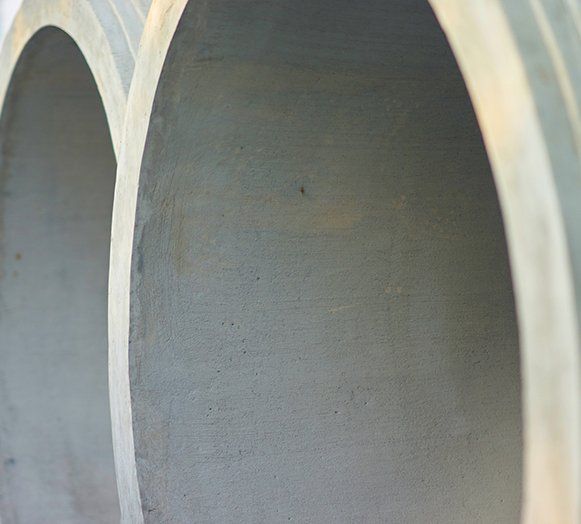 Big Cement Pipes in Stack — Roxboro, NC — Premium Tanks & Stone Big Cement Pipes in Stack — Roxboro, NC — Premium Tanks & Stone
