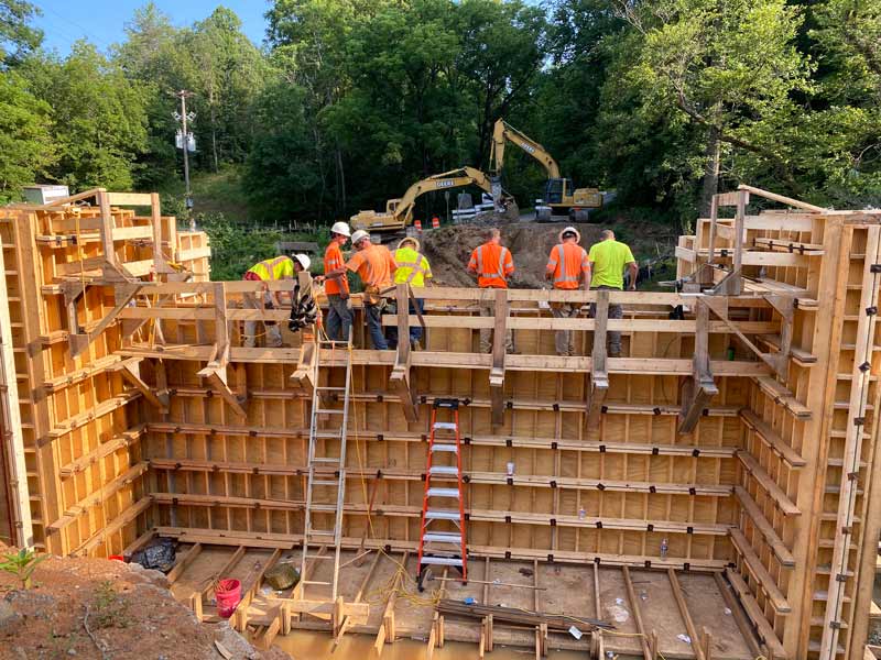 group of workers constructing wood structure