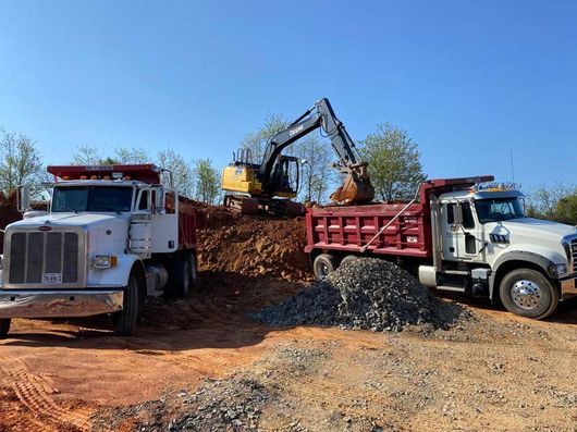 excavator and two dump trucks