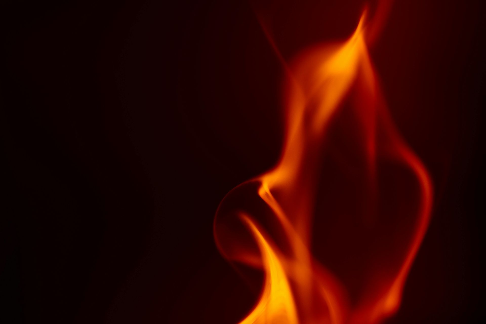 Orange and yellow flames against a dark red/black background.