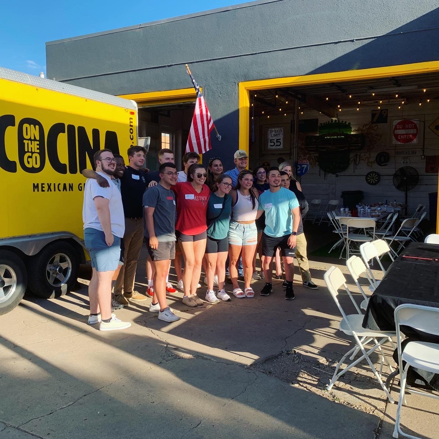 A group of people standing in front of a cocina truck