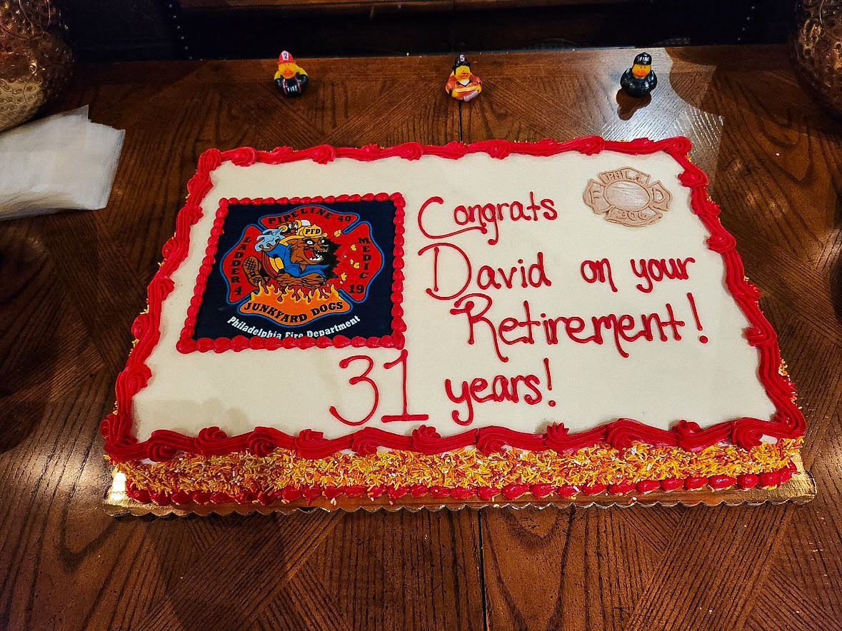 Cake celebrating David's retirement, with a fire department logo, red frosting, and 