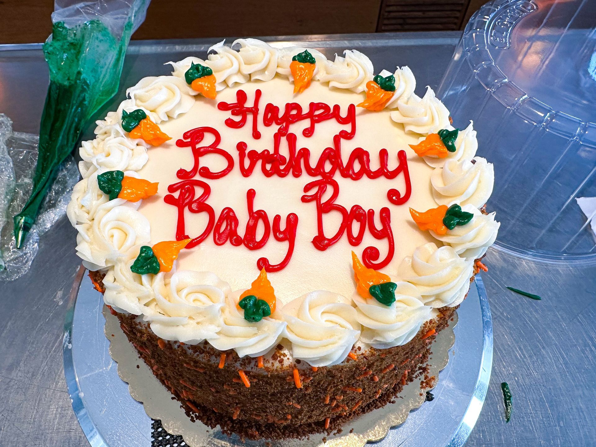 Carrot cake decorated with white frosting and red 