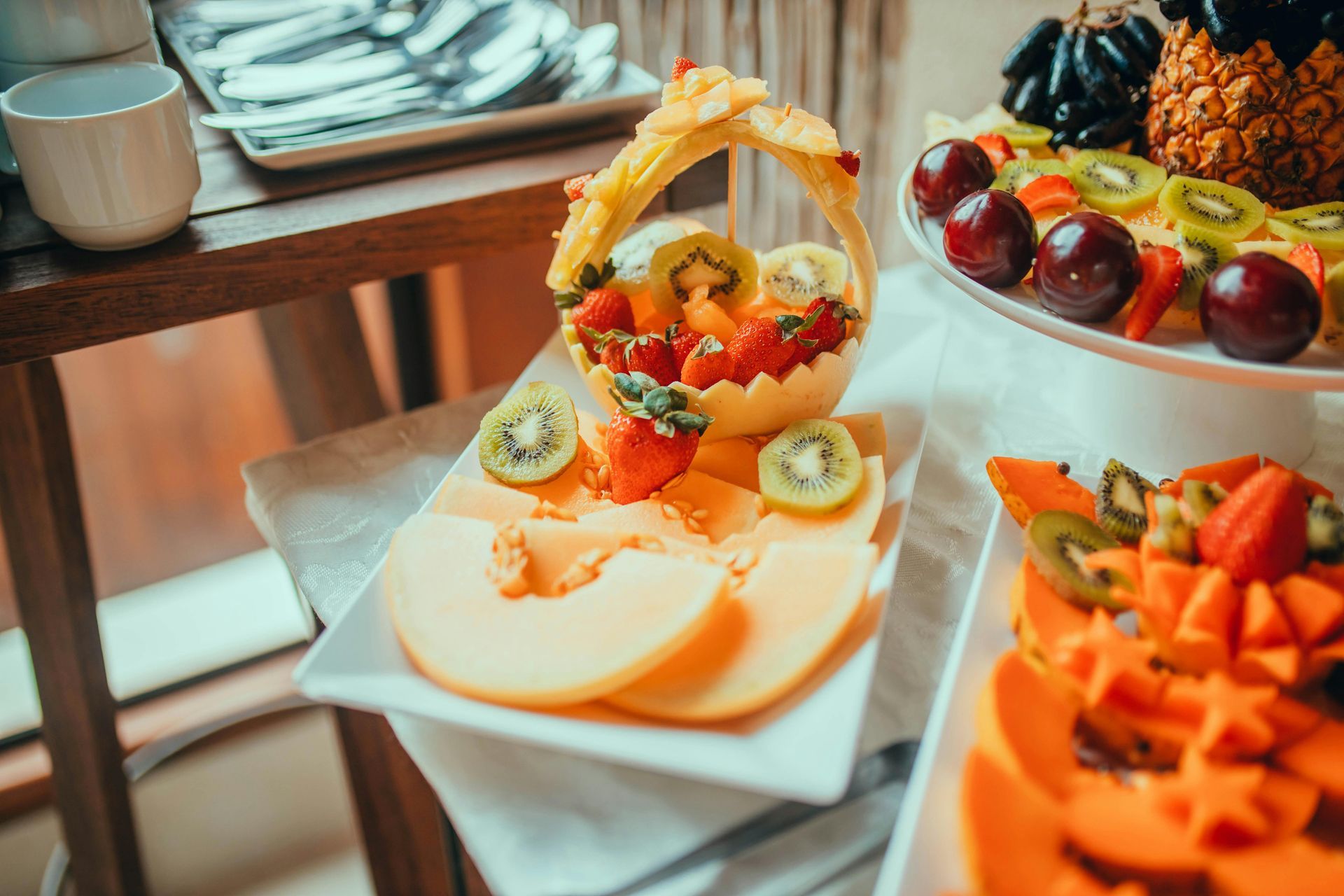Fruit platter with a variety of colorful fruits arranged on a table.
