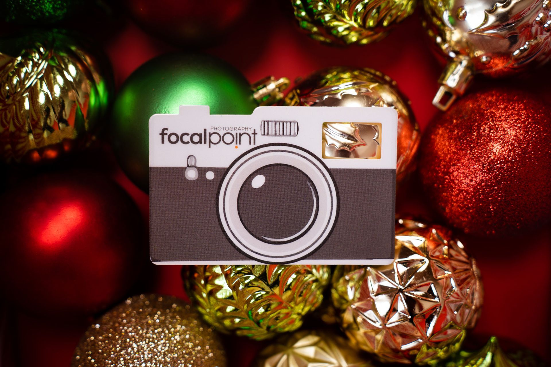 A focalpoint camera is surrounded by christmas ornaments