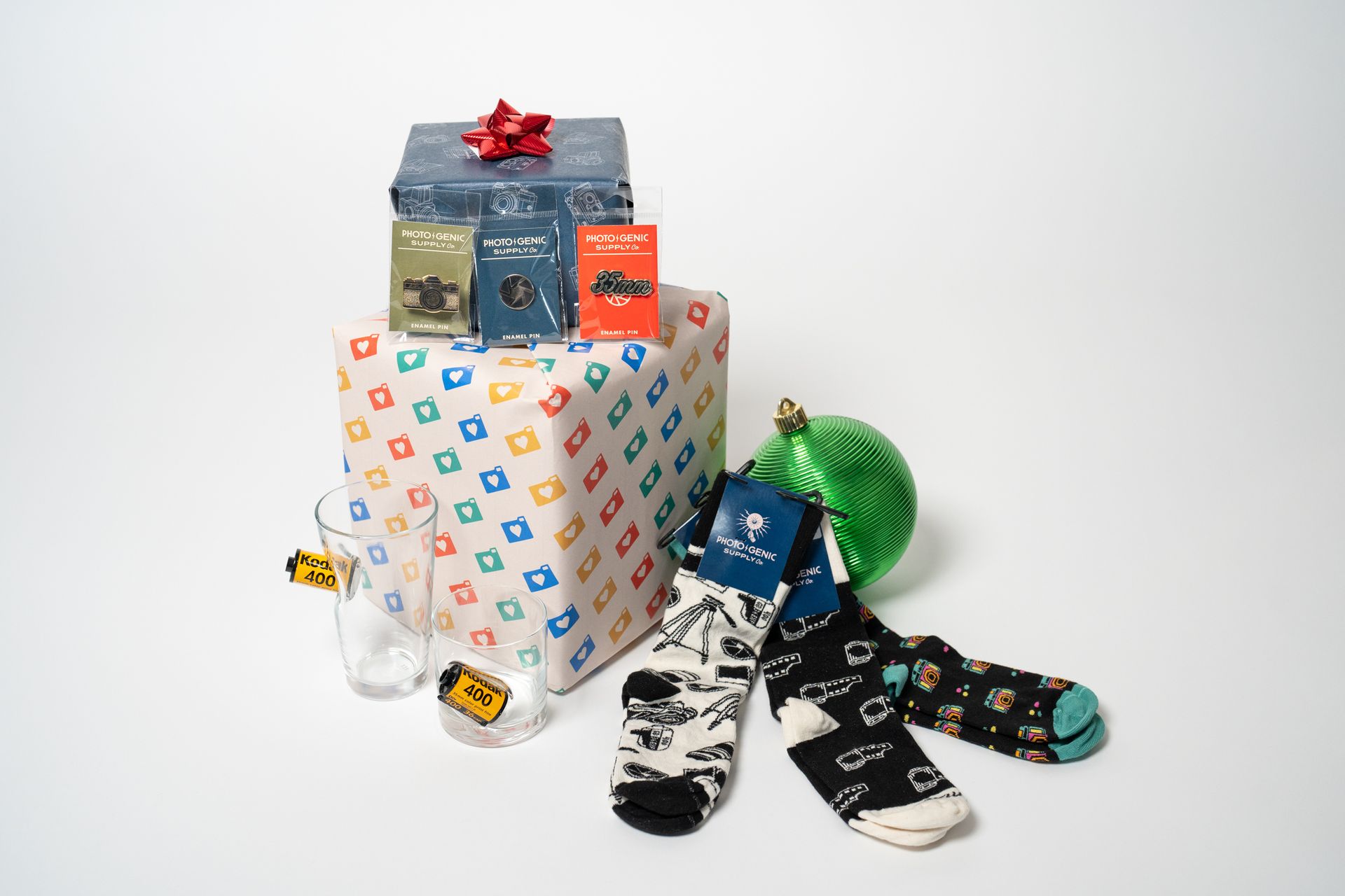 A stack of wrapped gifts and socks on a table.