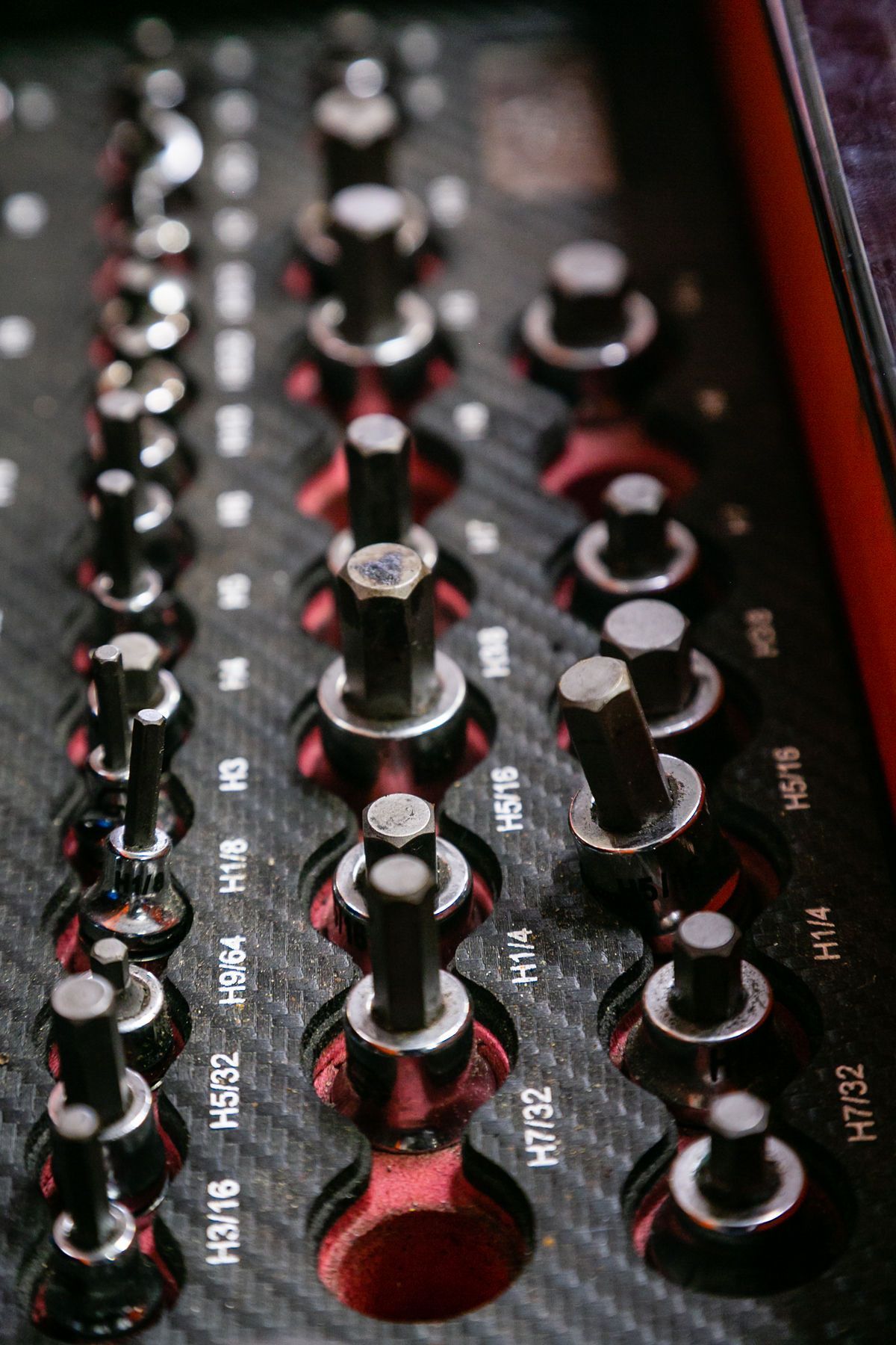 A close-up of a tool organizer tray containing various labeled hexagonal (Allen) bits of different sizes. | 2 QuickAuto, Car & Tire Repair | Copperfield