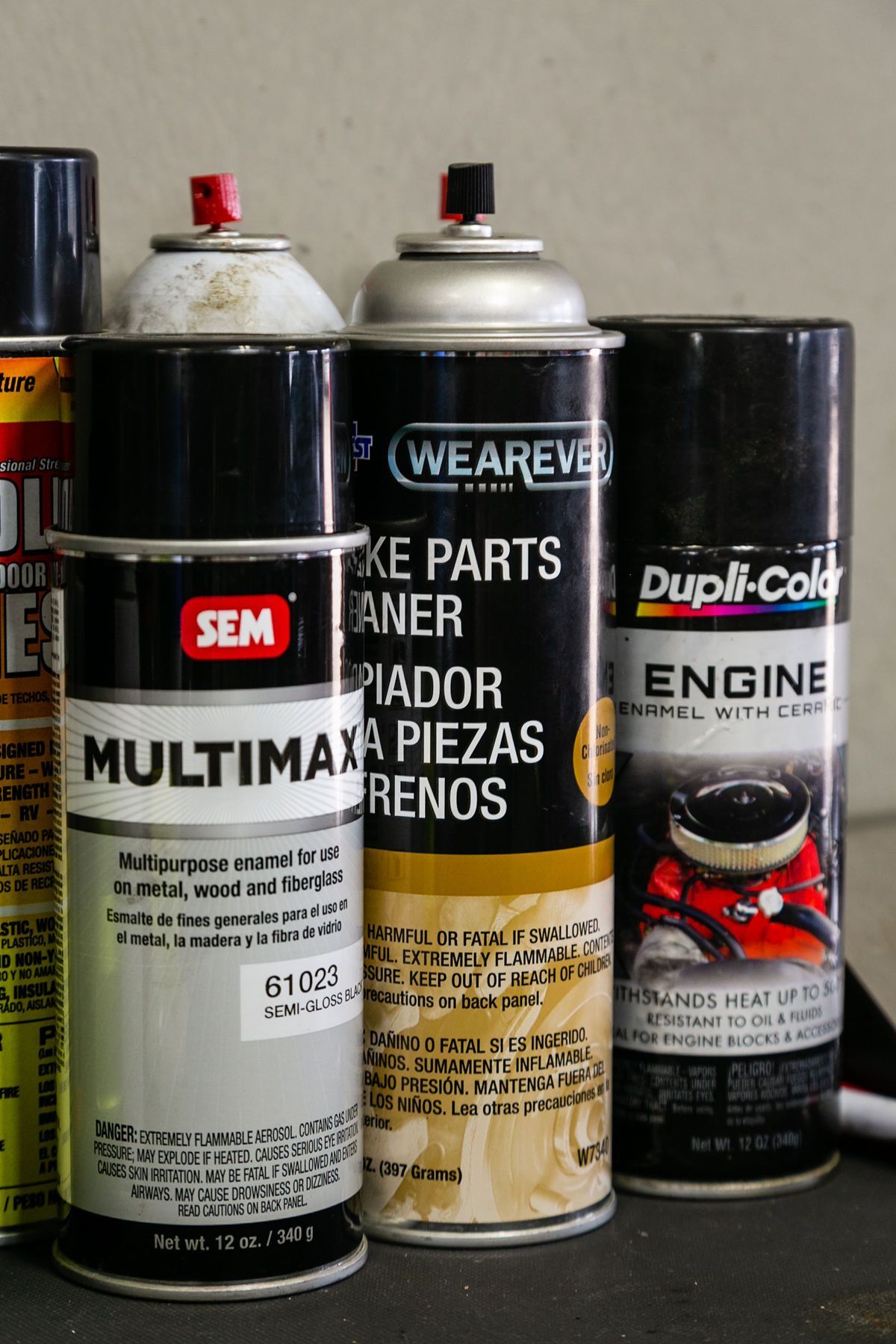 A collection of four automotive spray cans, including SEM Multimax, Wearever Brake Parts Cleaner, and Dupli-Color engine paint. | 2 QuickAuto, Car & Tire Repair | Copperfield