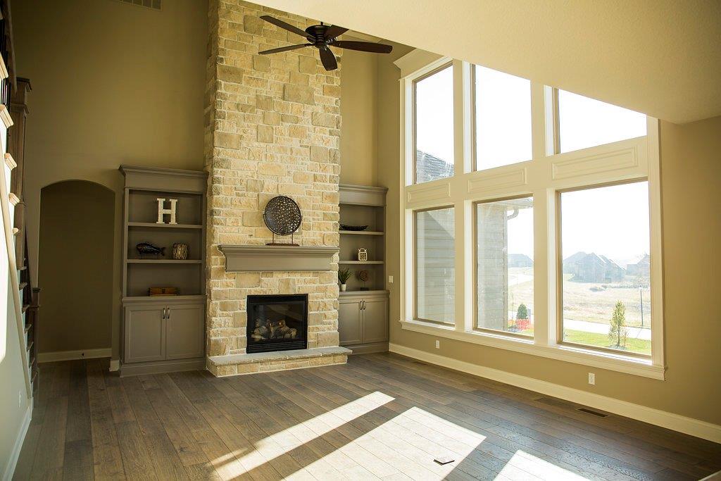Living Room With Large Windows & Custom Fireplace by Hansman Custom Homes in Mid-MO