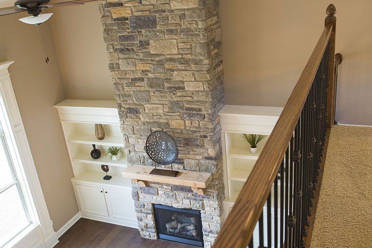Staircase View of a Custom Fireplace in Mid-Missouri by Hansman Custom Homes