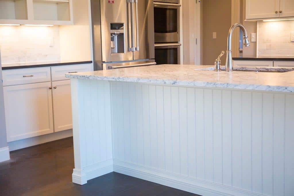 Big White Kitchen Island by Hansman Custom Homes in Mid-Missouri With Marble Counter