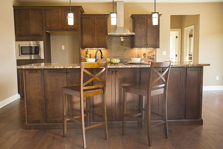 Dark Wood Kitchen Island & Chairs by Hansman Custom Homes in Mid-Missouri