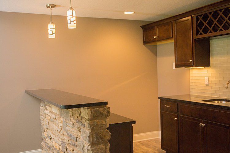 Wet Bar With Stone Counter by Hansman Custom Homes in Mid-MO