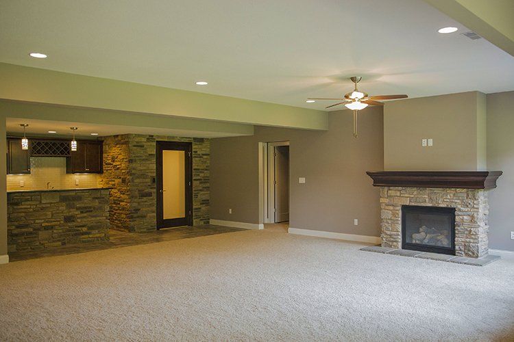 Empty Downstairs Living Room & Fireplace by Hansman Custom Homes in Mid-Missouri