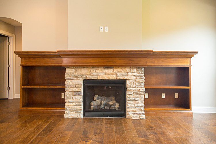Wood & Stone Fireplace With Shelves by Hansman Custom Homes in Mid-MO