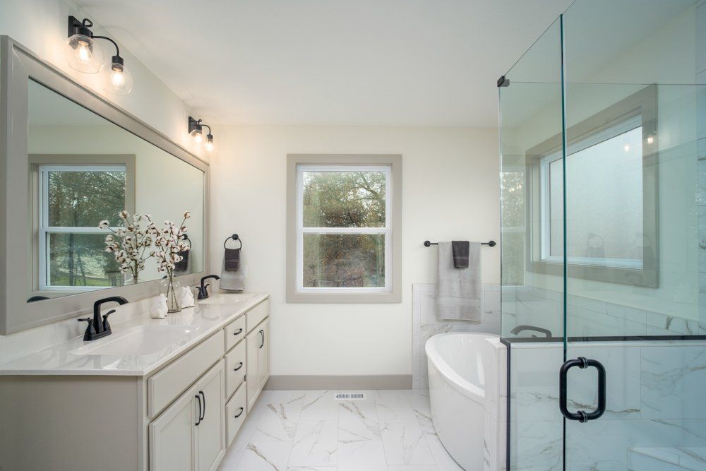 A New Bathroom With a Bathtub & Walk-in Shower by Hansman Custom Homes in Mid-MO