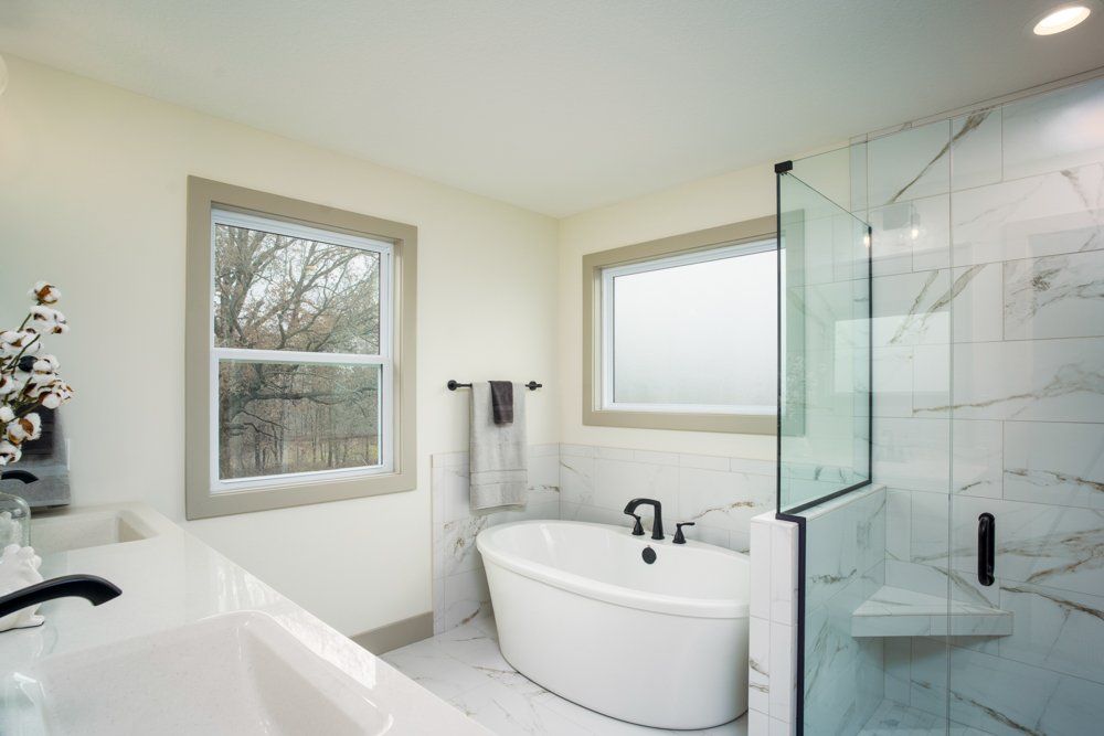 A Spacious Bathroom With Bathtub & Walk-in Shower by Hansman Custom Homes